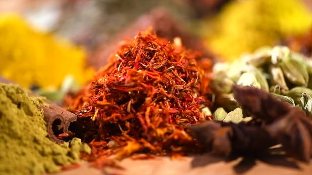 Spice. Various Indian spices and herbs rotated on wooden table. 4K UHD video 3840x2160