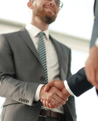 Friendly smiling businessmen handshaking. Business concept photo