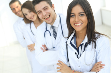 female doctor with group of happy successful colleagues