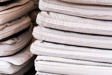 Stack of white seat pads in restaurant