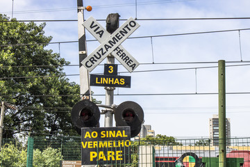 Level crossing between the street and railroad with traffic light and write 