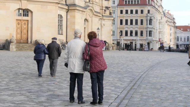 Dresden Germany senior couple people tourists walk watch historical city center