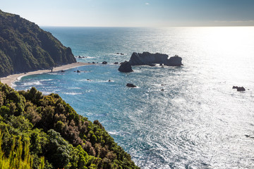Rock formations on the coastal beach near Bruce Bay on the south island of New Zealand