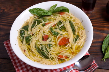 Plate of soup with cherry tomatoes and pecorino   