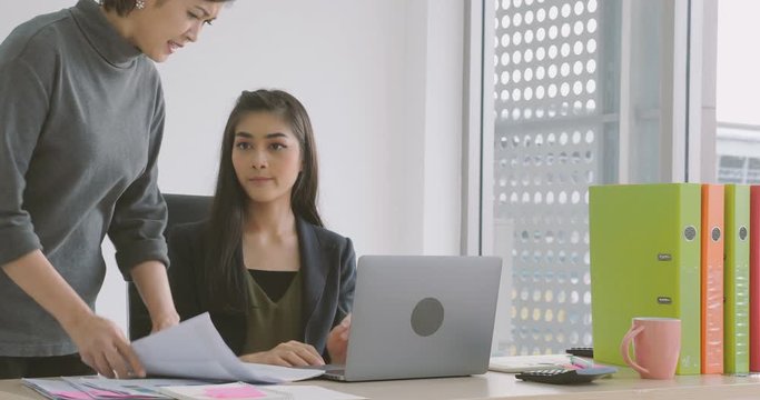 Young asian businesswoman getting rebuke from his female boss in the office.