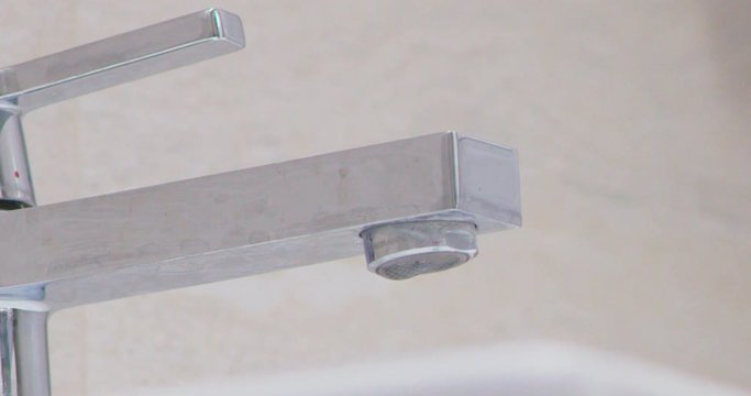 water droplets on tap in batroom leaking