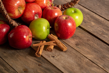 Apples red and green on rustic wooden table in basket 