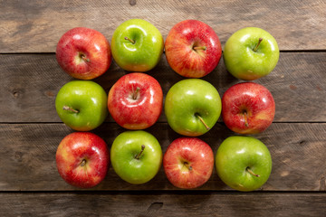 Apples red and green on rustic wooden table in basket 