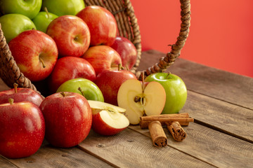 Apples red and green on rustic wooden table in basket 