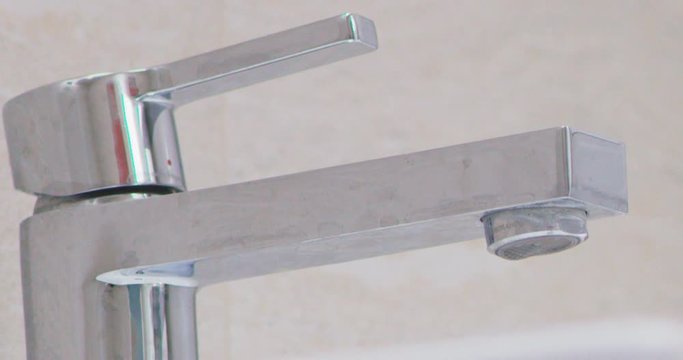 water droplets on tap in batroom leaking