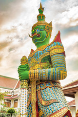 Fototapeta premium Statues at Wat Arun monumental Buddhist temple in Bangkok, Thailand.