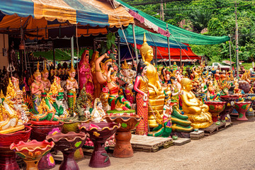 Fototapeta premium Religious artifacts on sale by the road in Lang Suan, Thailand
