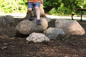 Toddler Jumping off a Rock Outside in the Forest - 213306204