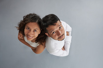 Asian man and hispanic woman with crossed arms