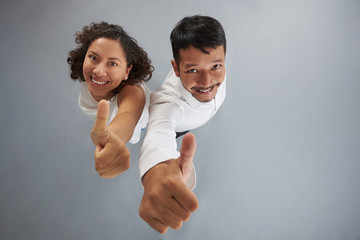 Young couple showing thumb up