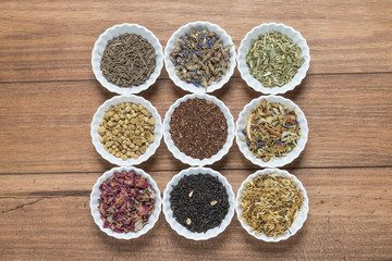 White bowls with different herbs for infusion.