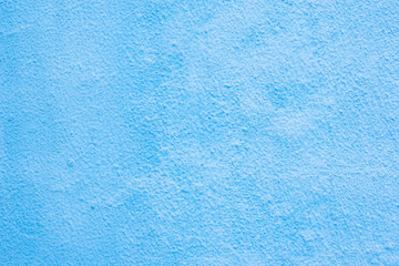Fototapeta na wymiar Background of a blue stucco coated and painted exterior, rough cast of cement and concrete wall texture, decorative coating