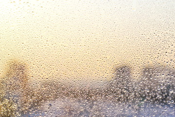 Rain drops and frozen water on window glass background