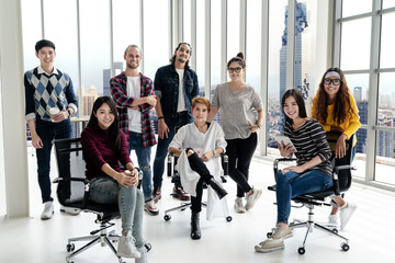 Portrait of happy diverse creative business team group looking at camera and smiling. Multiethnic success designer start up team working together on creative project. Group shot partnership concept.