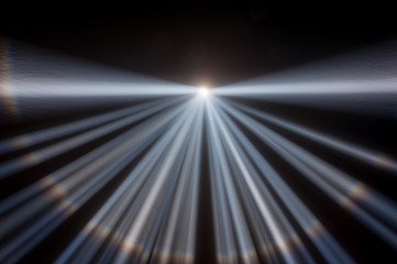 Multiple white spotlights shining up into a black night sky, converging at the center of the frame with a created horizon and rainbow