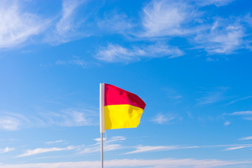 Surf life saving flag on the beach with blue water - Gold Coast, Queensland, Australia