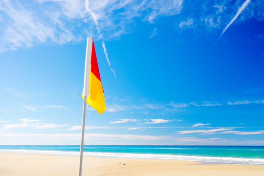 Surf Life Saving Flag On The Beach With Blue Water - Gold Coast, Queensland, Australia