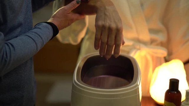 Closeup of a woman&rsquo;s hand after she pulled it out of the hot paraffin wax treatment.