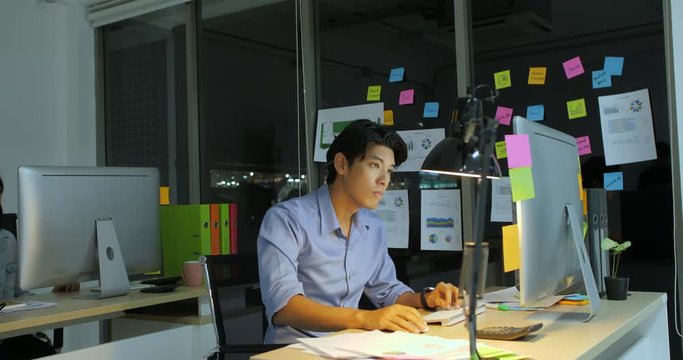 Businessman working late at night, He's the Only One Left on the Dark Office.