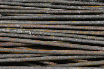 Old, rusty and brown metal rods background surface