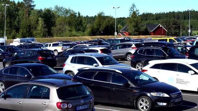 Cars parked at parking lot in norway, panning video airport