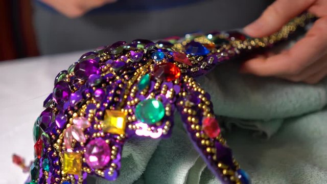 Wide shot showing rhinestones glued into place on a belly dance costume or bedlah.