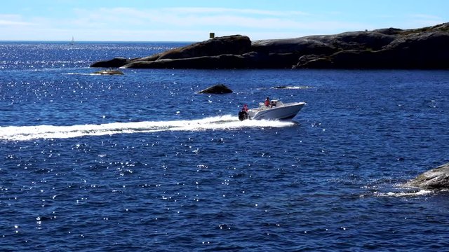 Speedboat yacht boat coming at high speed with norwegian flag at kjerringvik norway north sea