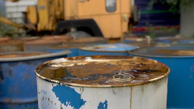 The oil is pouring on ld dirty barrels