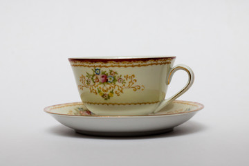 An isolated porcelain cup in a saucer