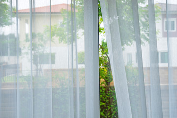 transparent white curtain at house village