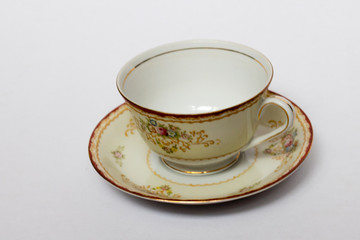 An isolated porcelain cup in a saucer