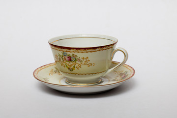 An isolated porcelain cup in a saucer