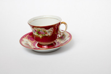 An isolated porcelain cup in a saucer