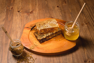 Jar of honey with honeycomb on wooden table. delicious honey honey