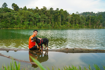 Man and dog playing in the lake
