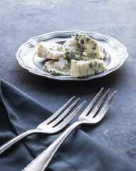 Cheese concept on the dark table.