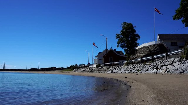 Sandy beach at Kjerringvik in Norway, sunny weather with blue sky.