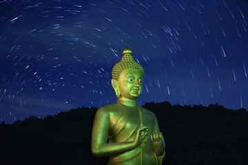 giant Buddha statue in the maelstrom of stars comets. the stillness in the chaotic ever changing...