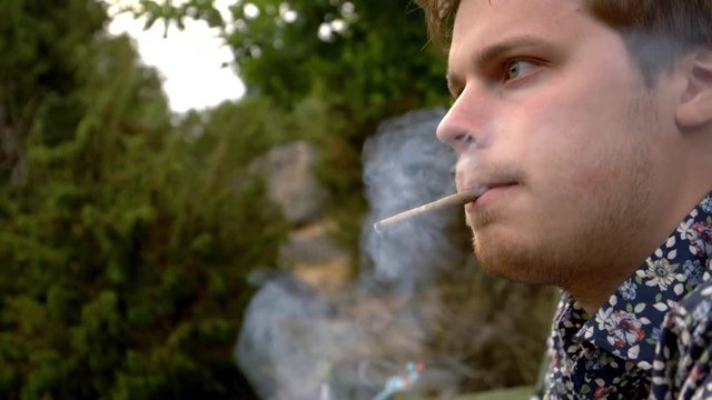A handsome man smoking a cigarill