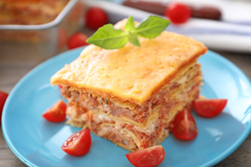 Plate with tasty lasagna on table