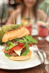 Plate with tasty fresh burger on table