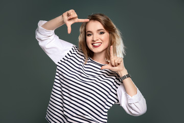 Fototapeta premium Beautiful young woman posing on color background