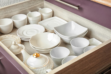 Ceramic dishware in kitchen drawer