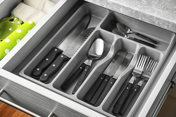 Set of cutlery in kitchen drawer