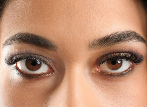 Attractive African-American woman with long eyelashes, closeup. Eyelash extensions